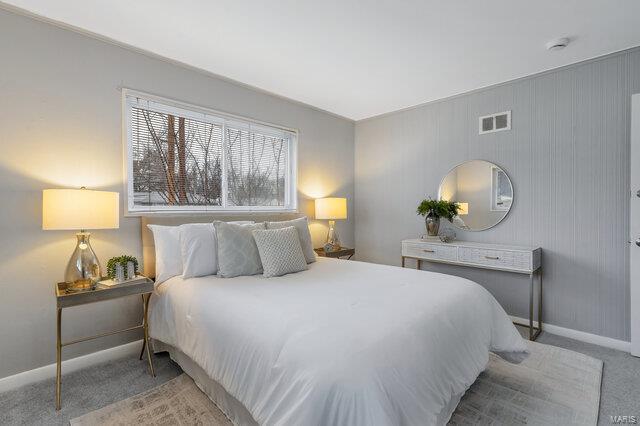 bedroom featuring light carpet