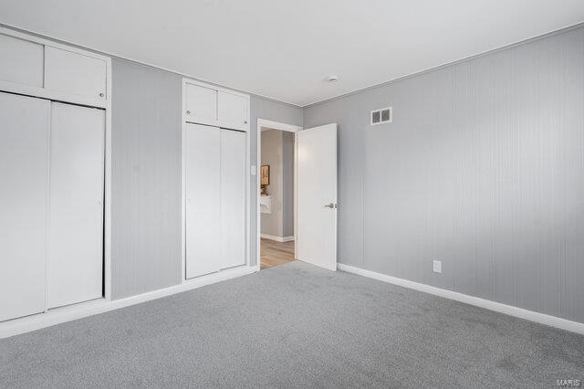 unfurnished bedroom with light colored carpet