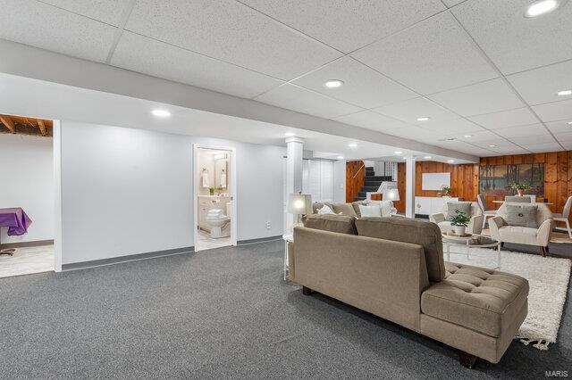 living room with a paneled ceiling