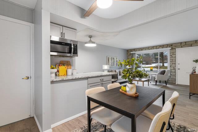 dining area featuring ceiling fan and light wood-type flooring