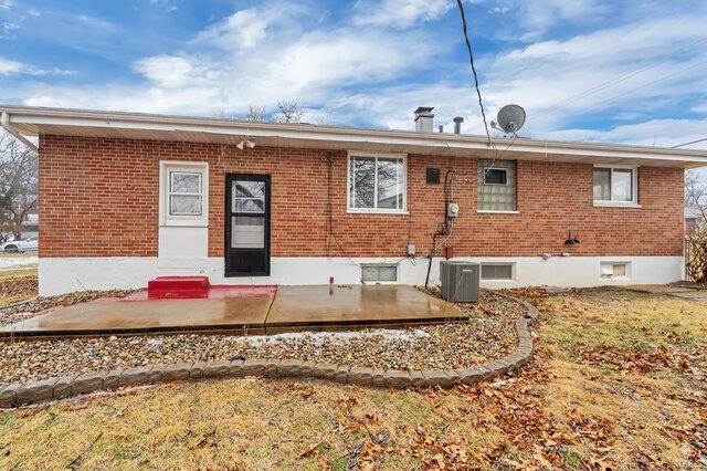 rear view of house featuring cooling unit