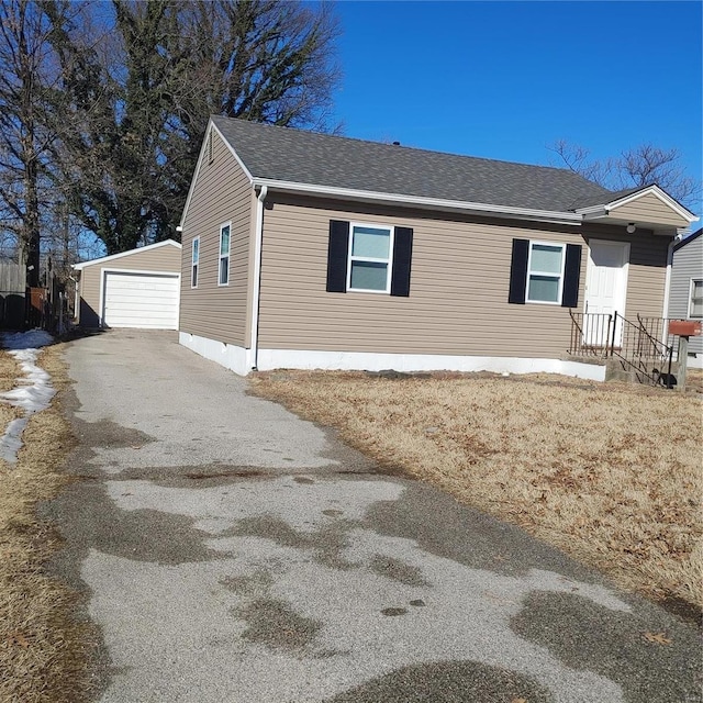 view of property exterior with a garage and an outbuilding