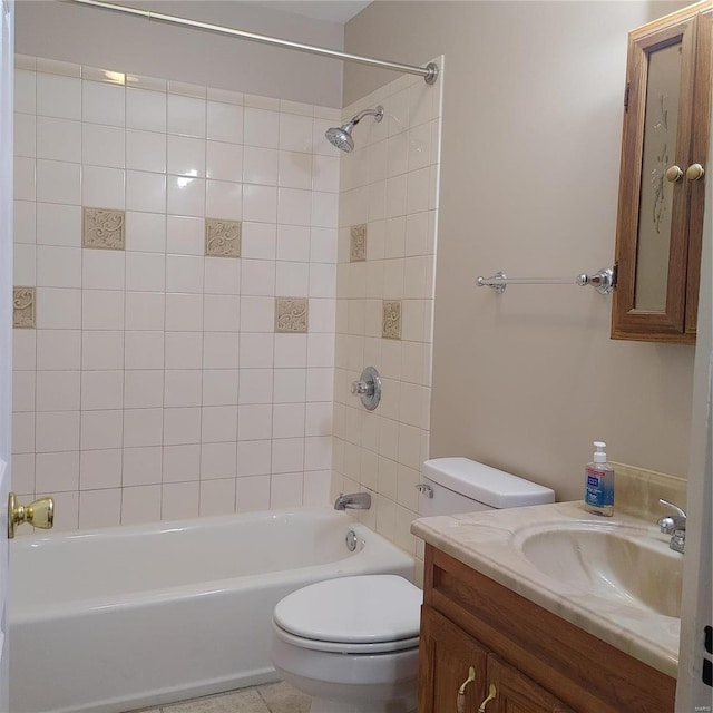 full bathroom with vanity, tiled shower / bath combo, and toilet