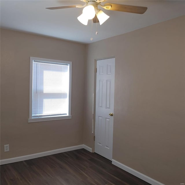 spare room featuring dark hardwood / wood-style floors and ceiling fan