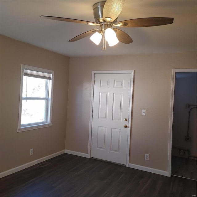 unfurnished bedroom with ceiling fan and dark hardwood / wood-style flooring