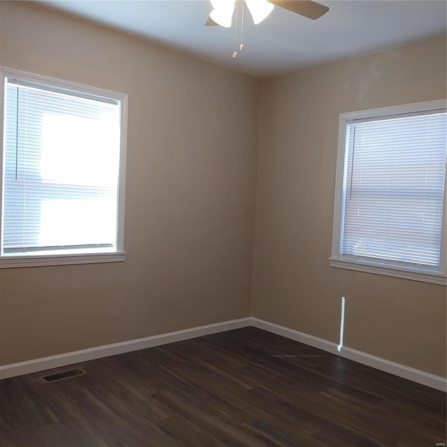 unfurnished room with dark hardwood / wood-style floors and ceiling fan