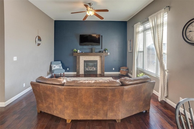 living room with ceiling fan and dark hardwood / wood-style flooring