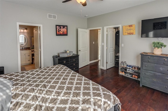 bedroom with dark hardwood / wood-style flooring, sink, connected bathroom, and ceiling fan