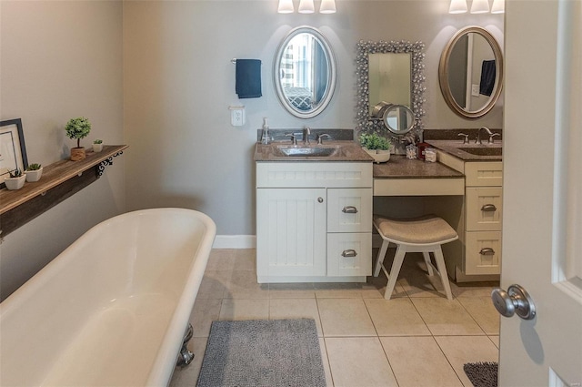 bathroom featuring vanity, tile patterned floors, and a tub