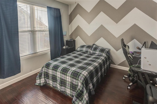 bedroom with dark hardwood / wood-style flooring