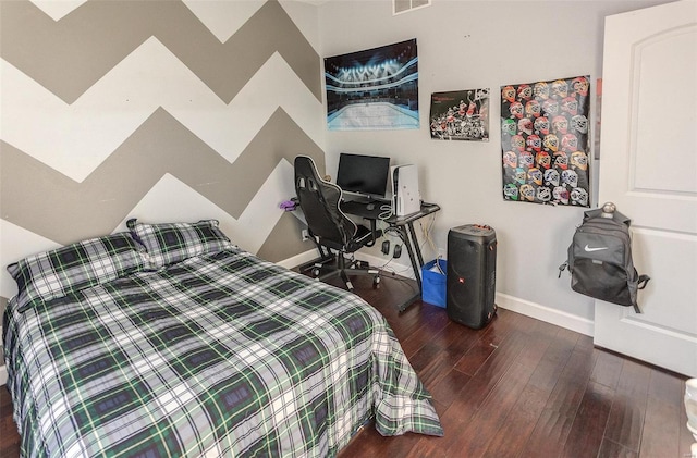 bedroom with dark hardwood / wood-style flooring