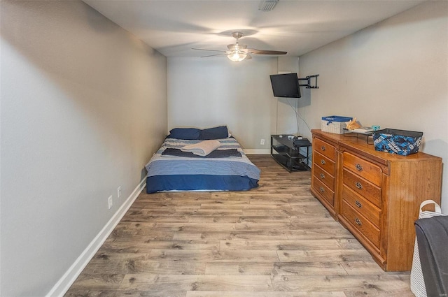 bedroom with light wood-type flooring and ceiling fan