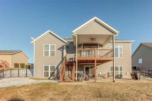 rear view of house featuring a yard, a deck, ceiling fan, and a patio area