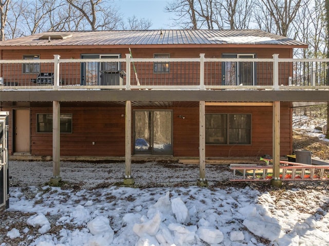 snow covered property with a deck