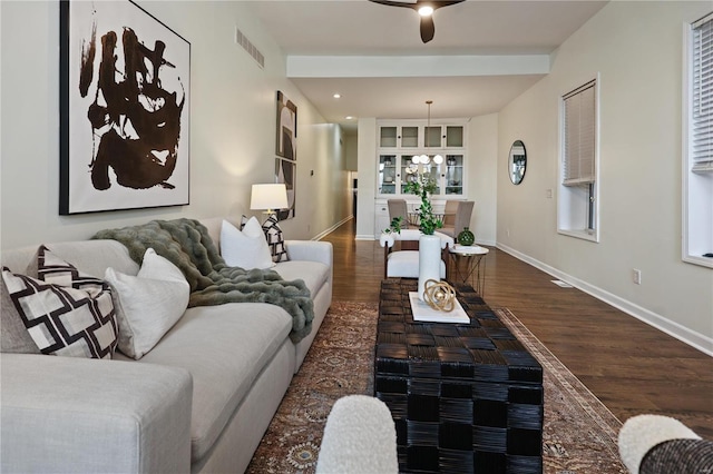 living room featuring dark hardwood / wood-style floors and ceiling fan