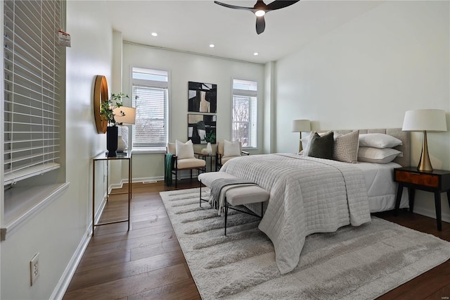 bedroom featuring multiple windows, dark wood-type flooring, and ceiling fan