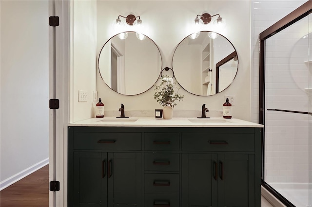 bathroom with vanity, wood-type flooring, and a shower