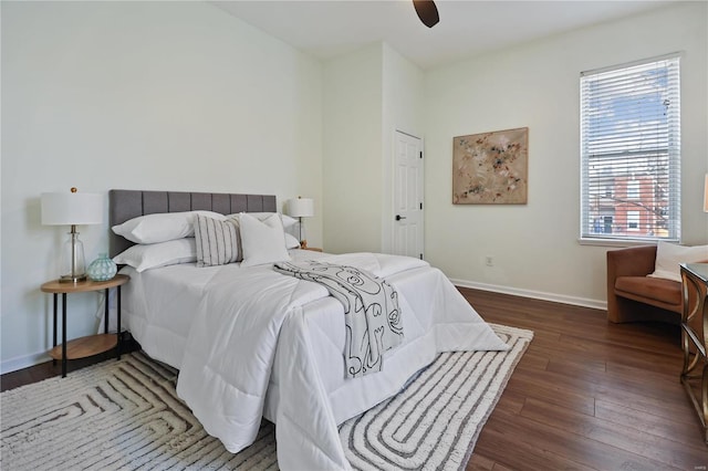 bedroom with dark hardwood / wood-style floors and ceiling fan