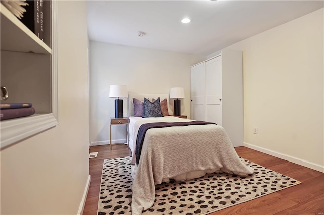 bedroom featuring hardwood / wood-style flooring and a closet