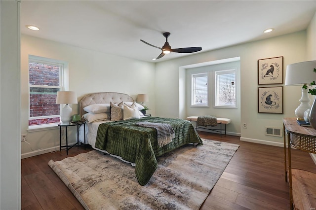 bedroom with dark hardwood / wood-style floors and ceiling fan