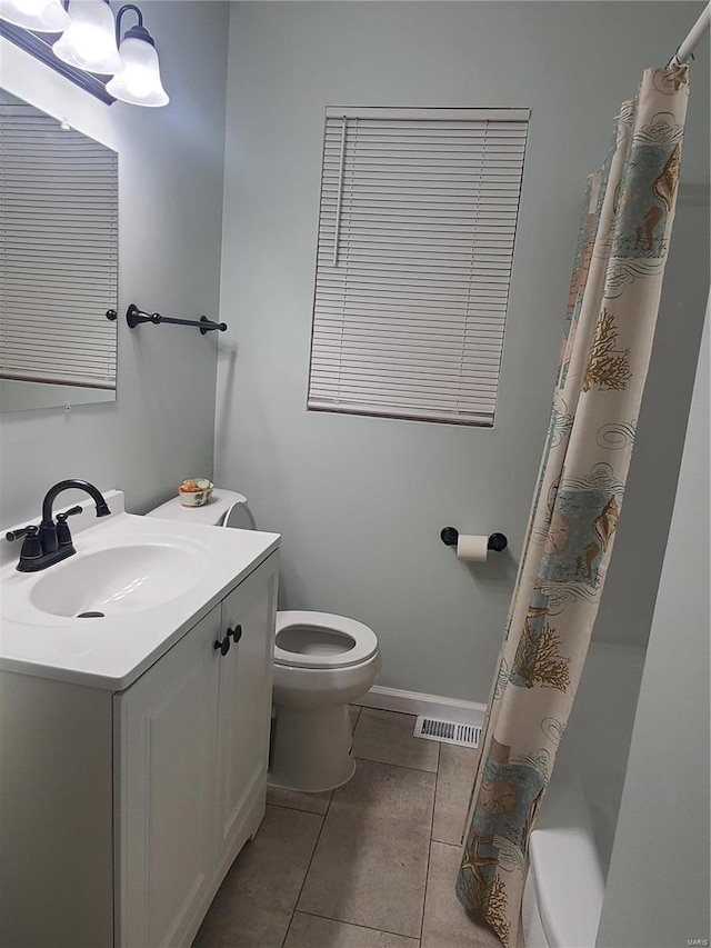 bathroom with vanity, toilet, and tile patterned flooring