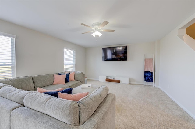 living room featuring carpet and ceiling fan