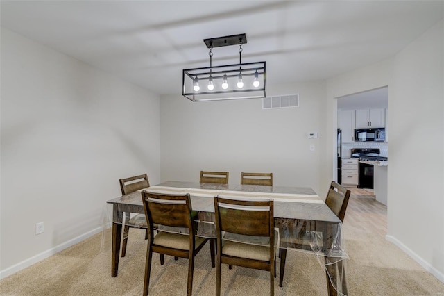 dining space with light carpet