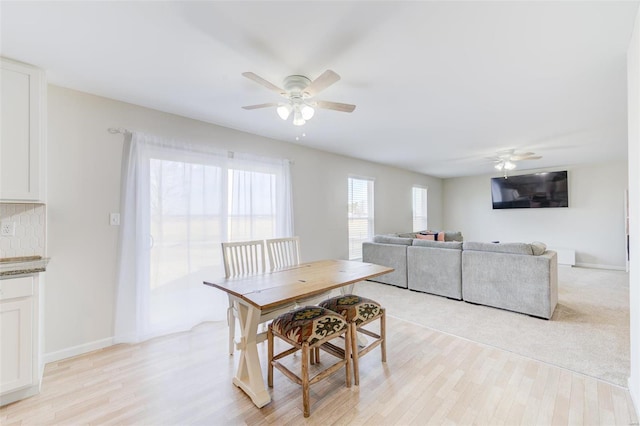 dining space featuring ceiling fan and light hardwood / wood-style flooring