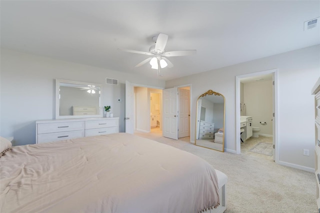 carpeted bedroom with connected bathroom and ceiling fan