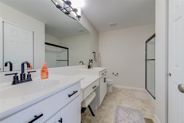 bathroom featuring vanity, an enclosed shower, and toilet