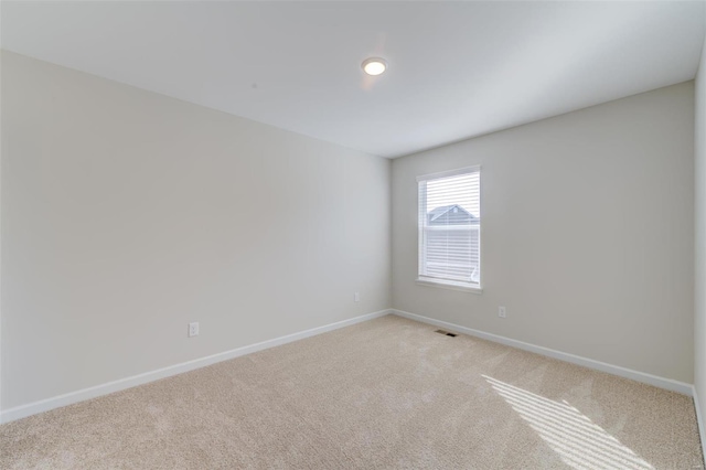 spare room with light colored carpet