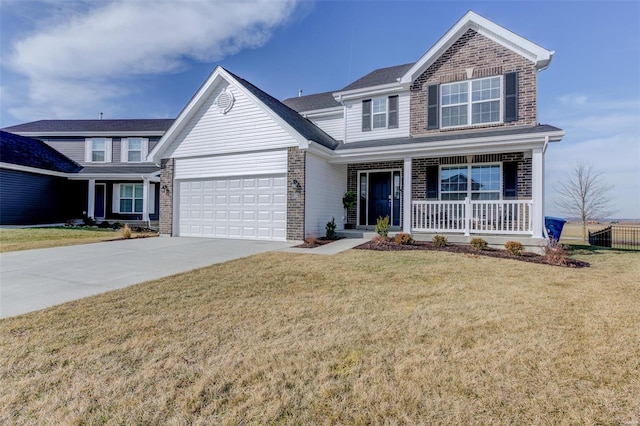 view of front of house featuring a garage, covered porch, and a front yard