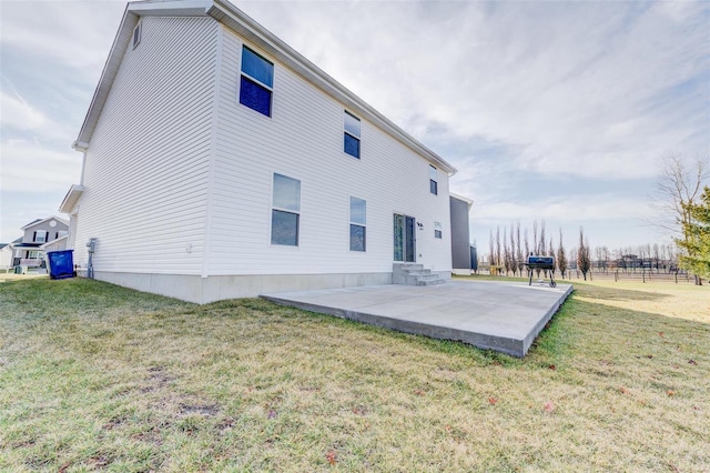 back of house with a yard and a patio area