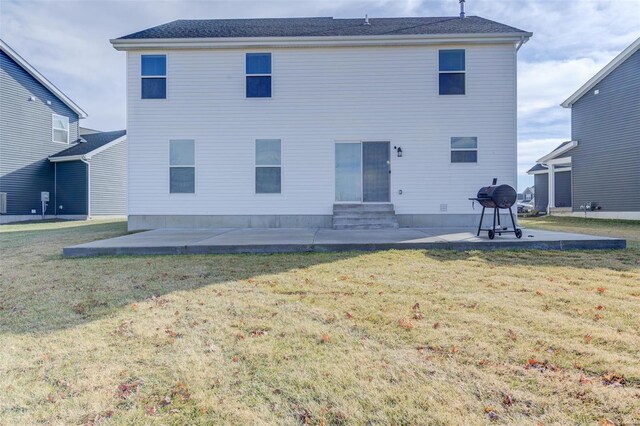 rear view of property featuring a patio and a lawn