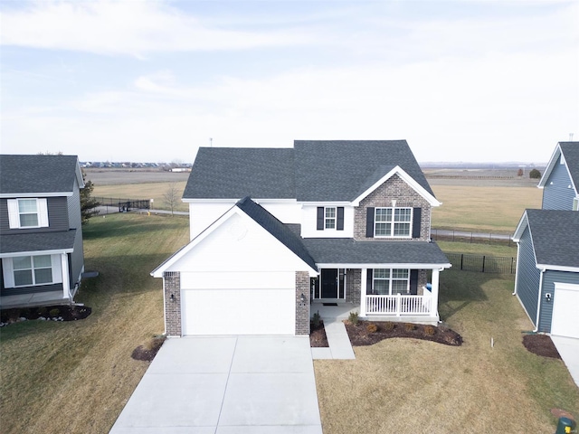 view of front facade featuring a garage, a front yard, and a porch