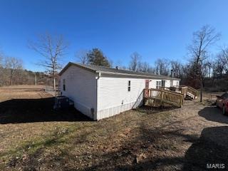 view of home's exterior featuring a deck