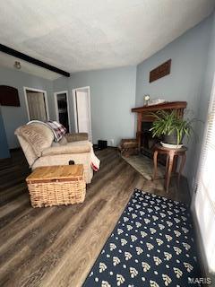 living room with beamed ceiling and dark hardwood / wood-style flooring