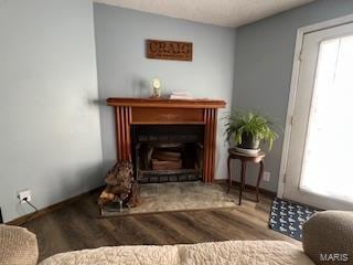 living area featuring wood-type flooring and a healthy amount of sunlight