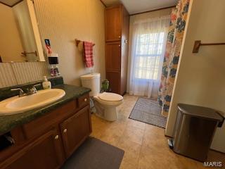 bathroom with tile patterned floors, vanity, and toilet