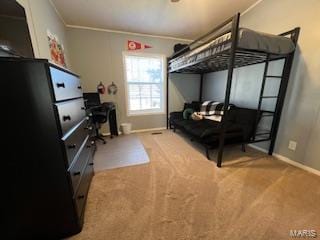 bedroom with ornamental molding and carpet