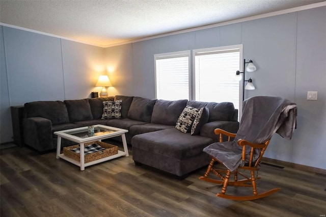 living room featuring a textured ceiling, ornamental molding, and dark wood-type flooring