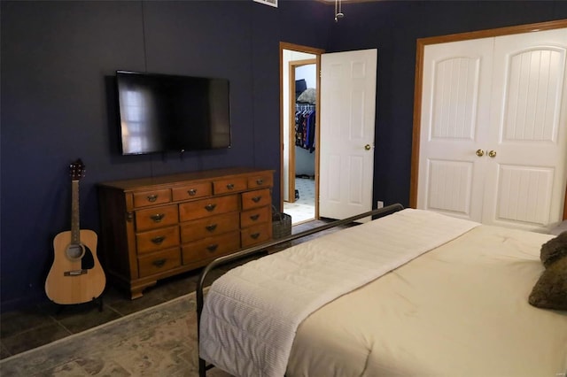 bedroom featuring dark tile patterned flooring and a closet