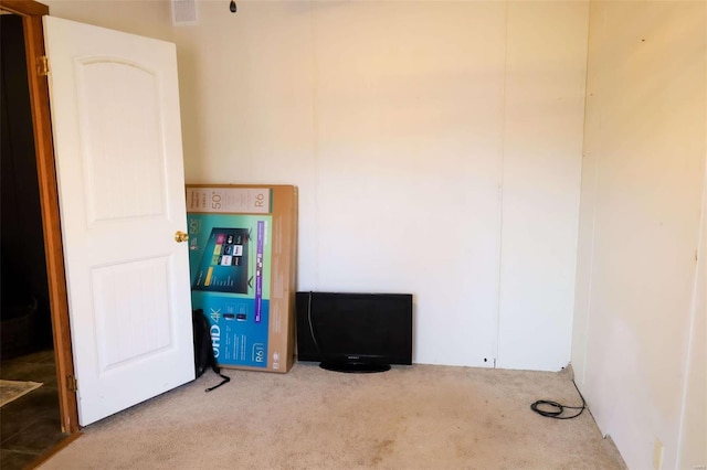 unfurnished room with carpet and visible vents