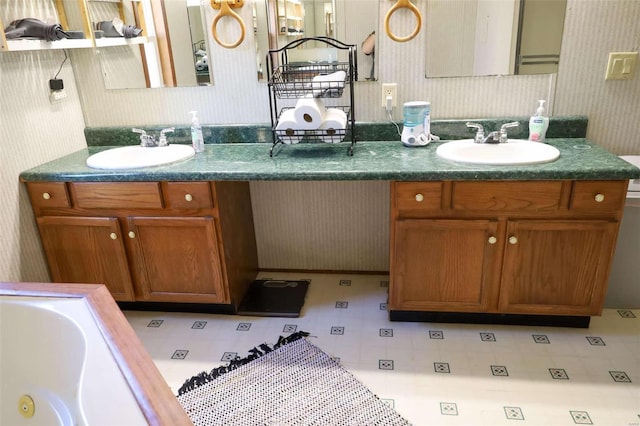 bathroom featuring a sink and wallpapered walls