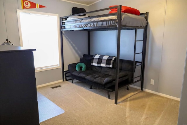 bedroom featuring visible vents, light carpet, and baseboards