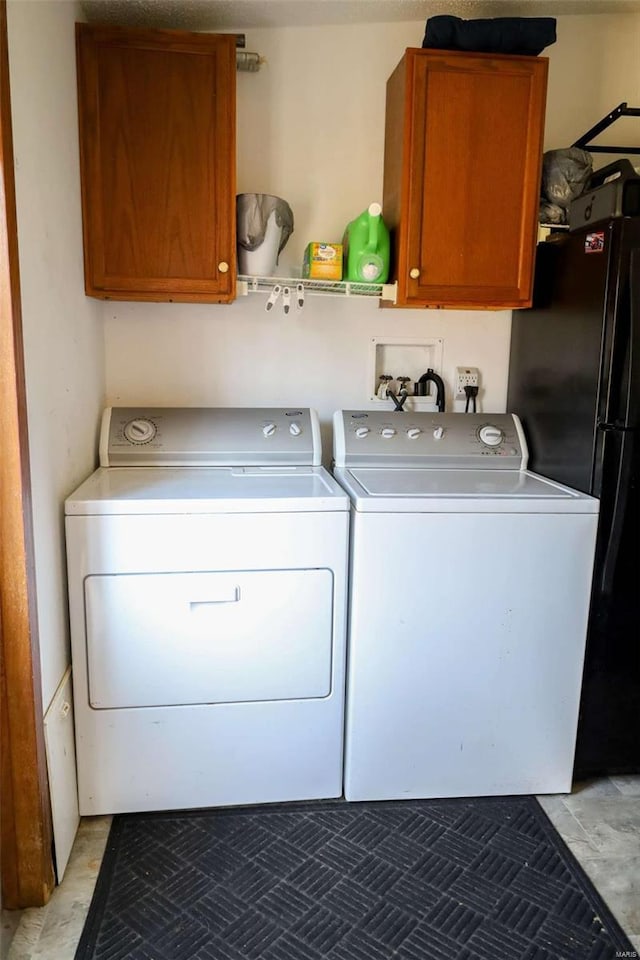 washroom with cabinet space and independent washer and dryer