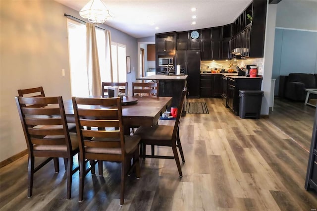 dining area featuring light wood-style flooring and recessed lighting