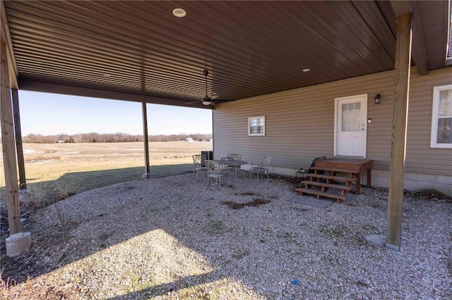 view of patio featuring ceiling fan and a rural view