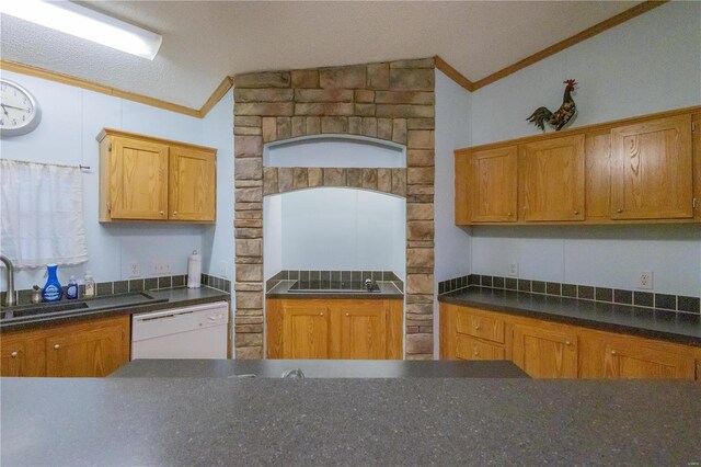 kitchen with dishwasher, vaulted ceiling, sink, and crown molding