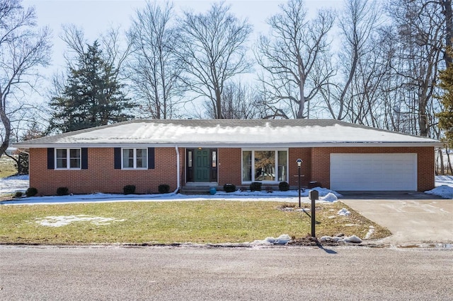 ranch-style home featuring a garage and a front lawn